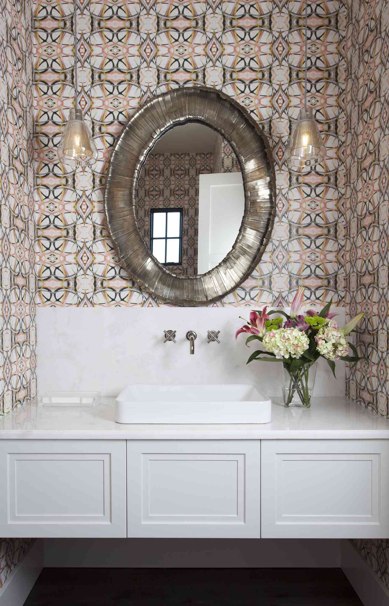 a pink powder bathroom with floating sink vanity