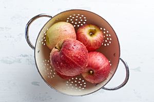 Freshly washed apples in a colander