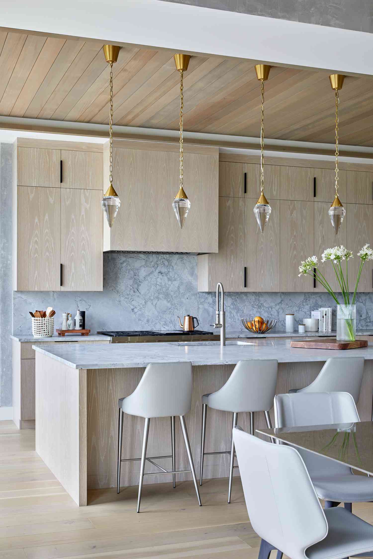 neutral color scheme and glass pendants modern kitchen