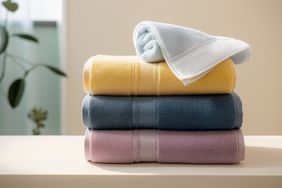 A neatly stacked set of folded towels organized in a pile
