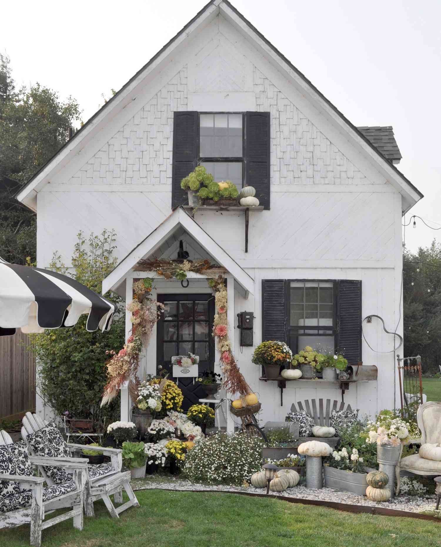 white house fall porch with bright flowers