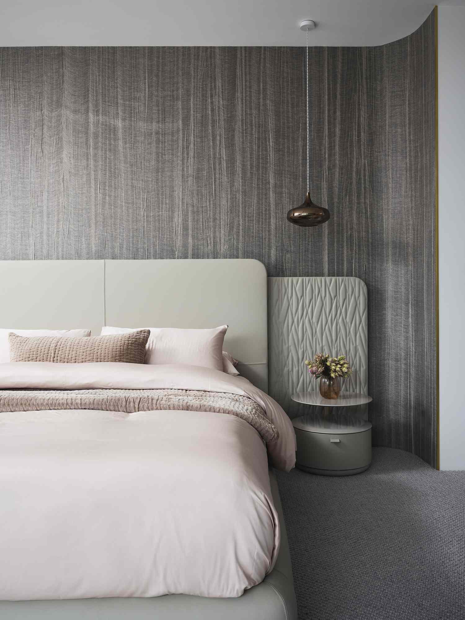 Pink bed against a gray wall