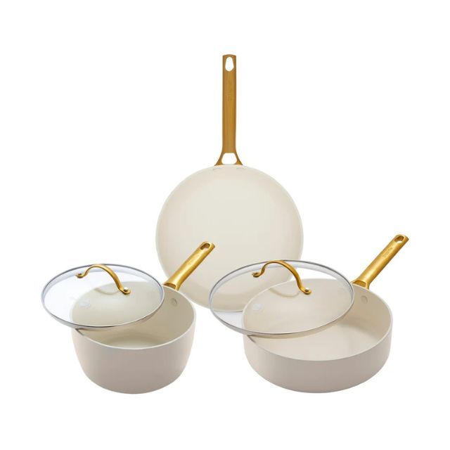 Three kitchen pots and pans with matching lids and gold handles