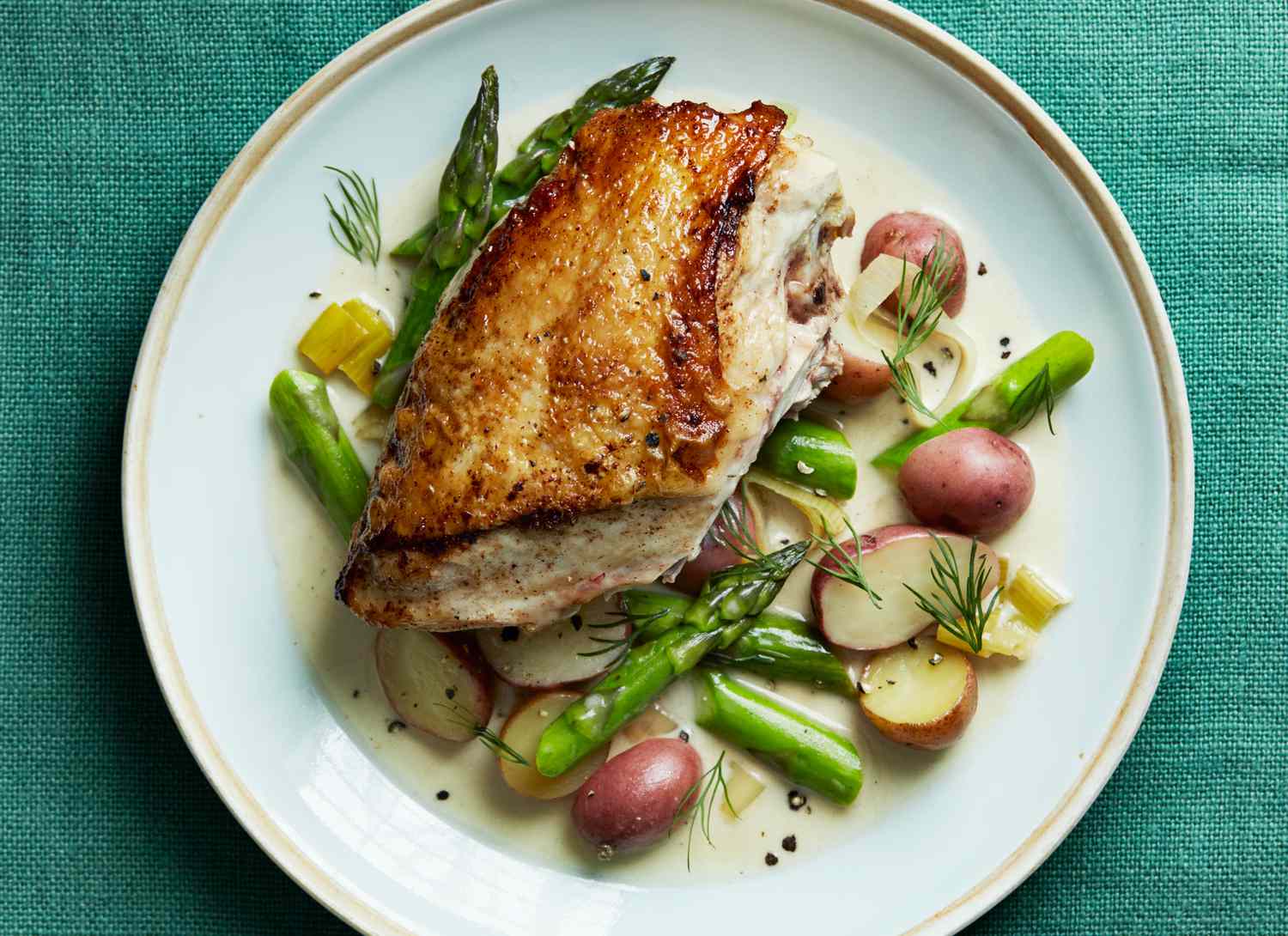 overhead view of a chicken dish with asparagus