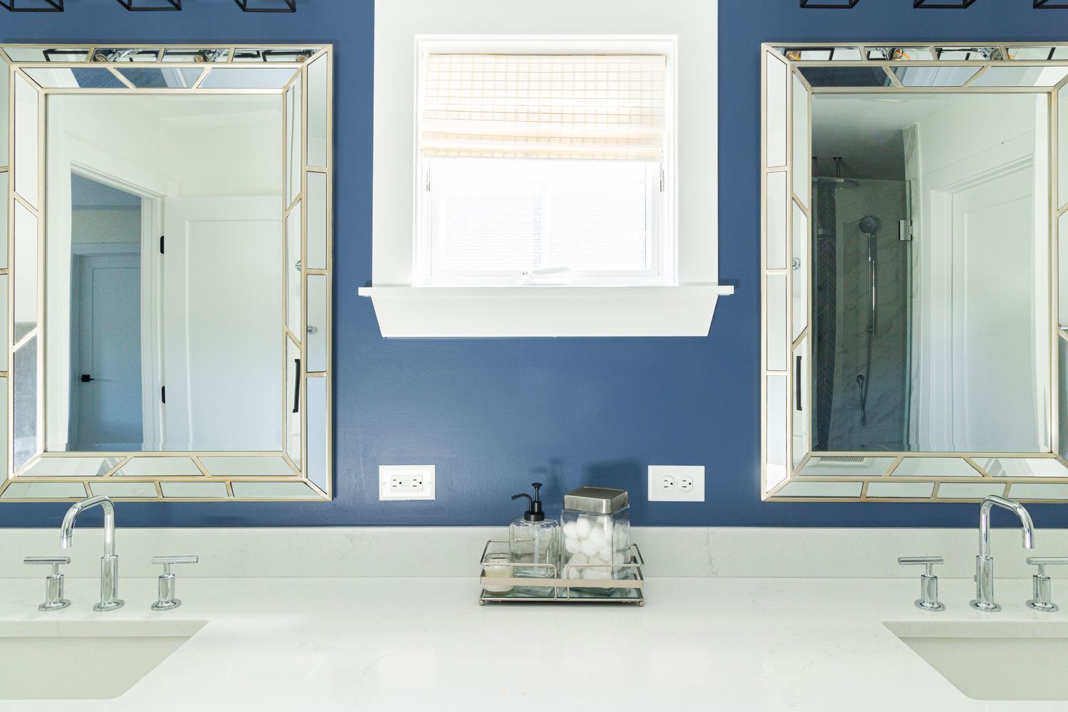 a blue bathroom with white countertops