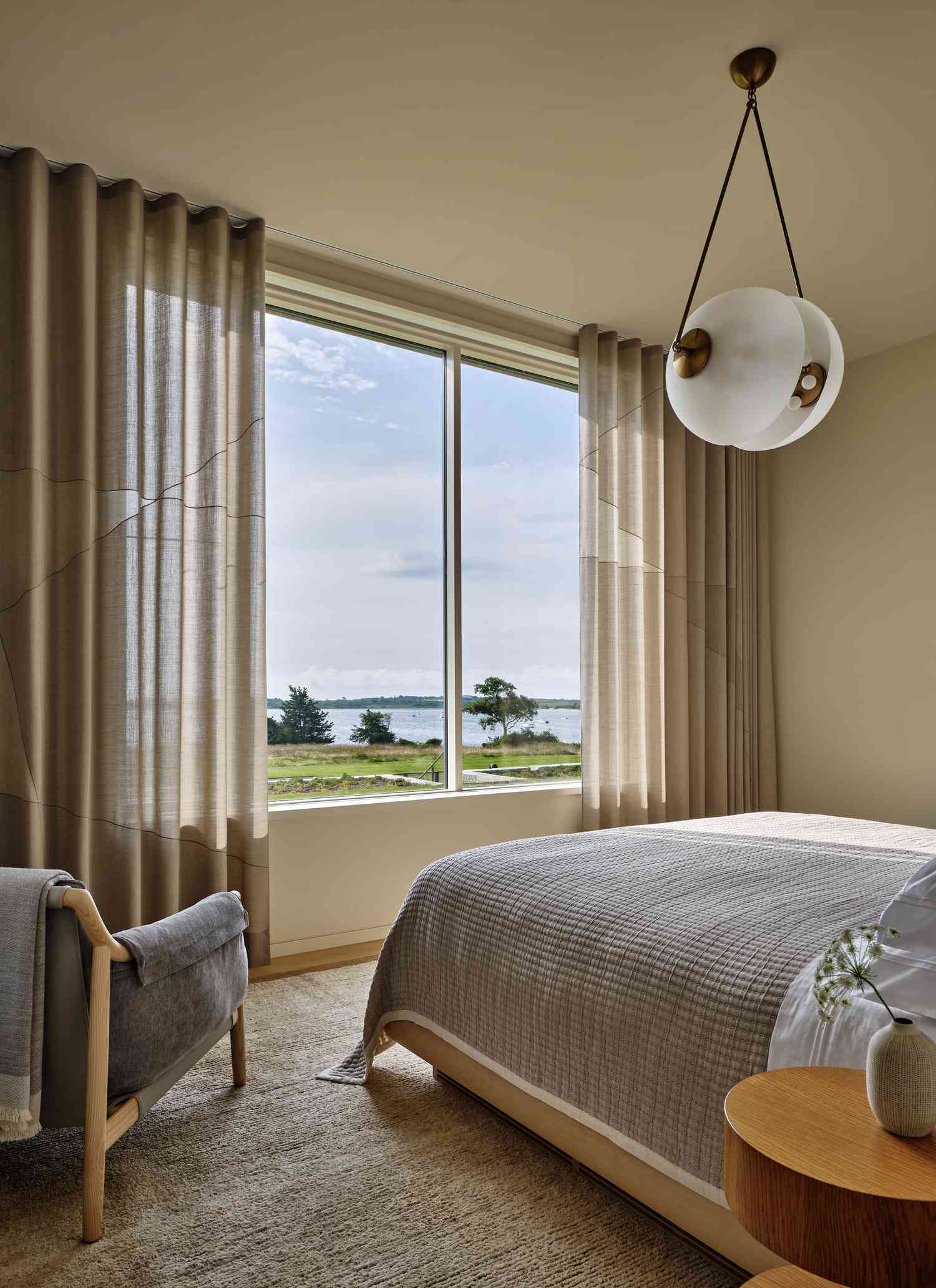 a neutral bedroom with a chandelier 