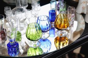 Array of colored glassware on a reflective surface