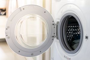 Open door of a frontloading washing machine showing the interior drum