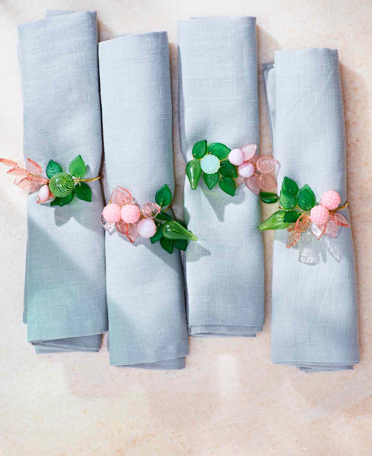 a set of napkins with floral napkin rings