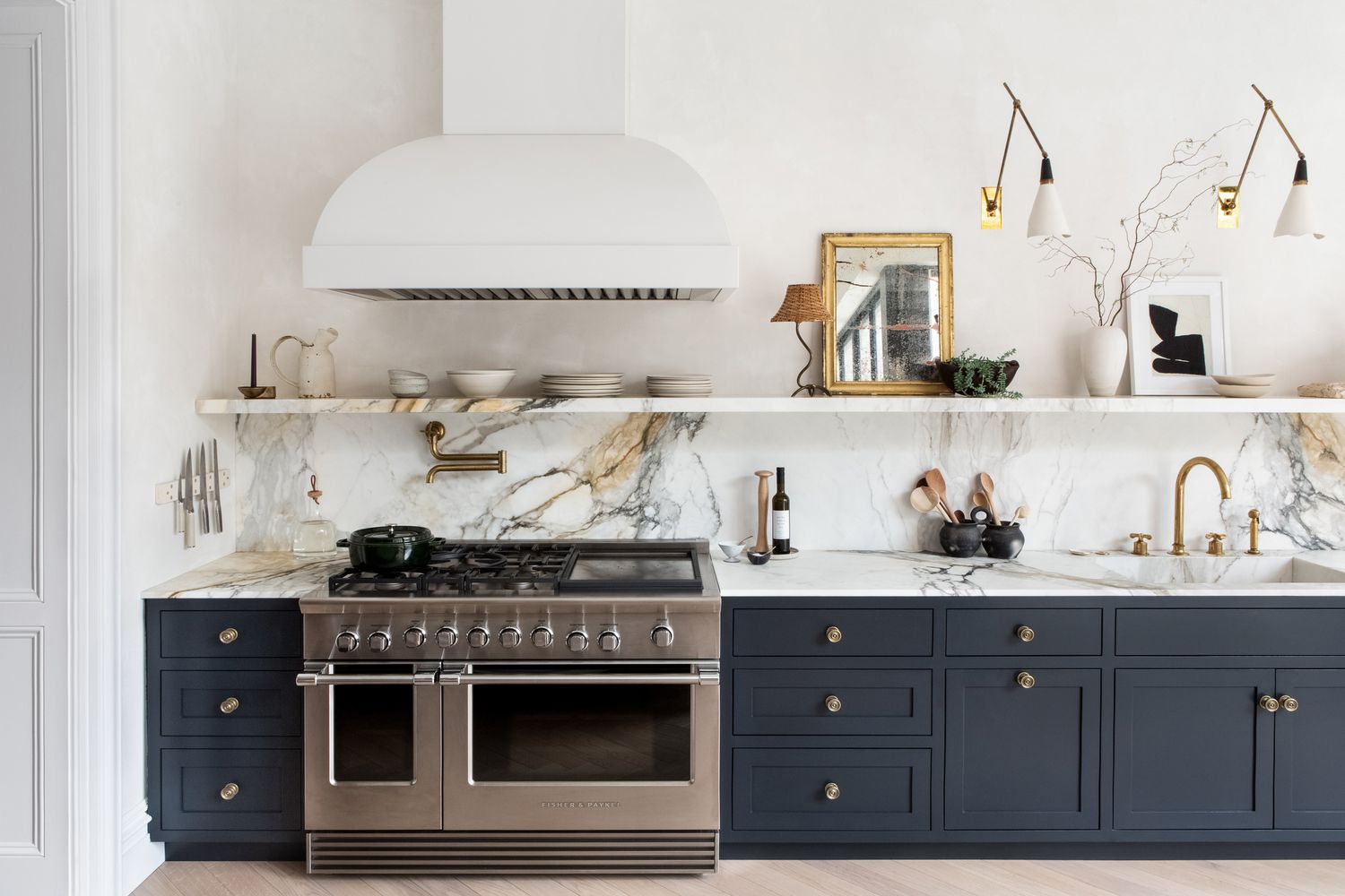 Kitchen with marble backsplash and blue cabinets
