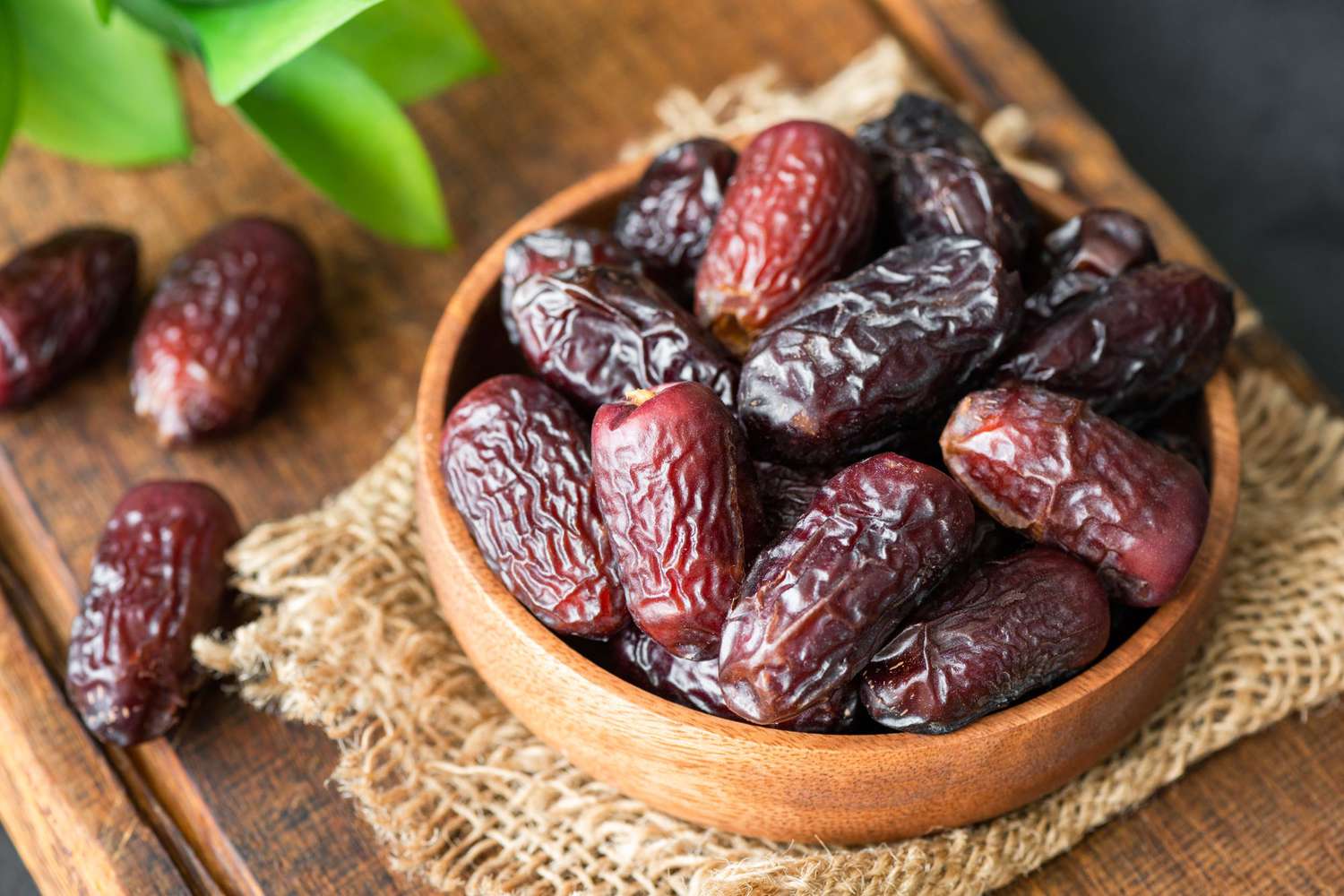 Dried dates in wooden bowl