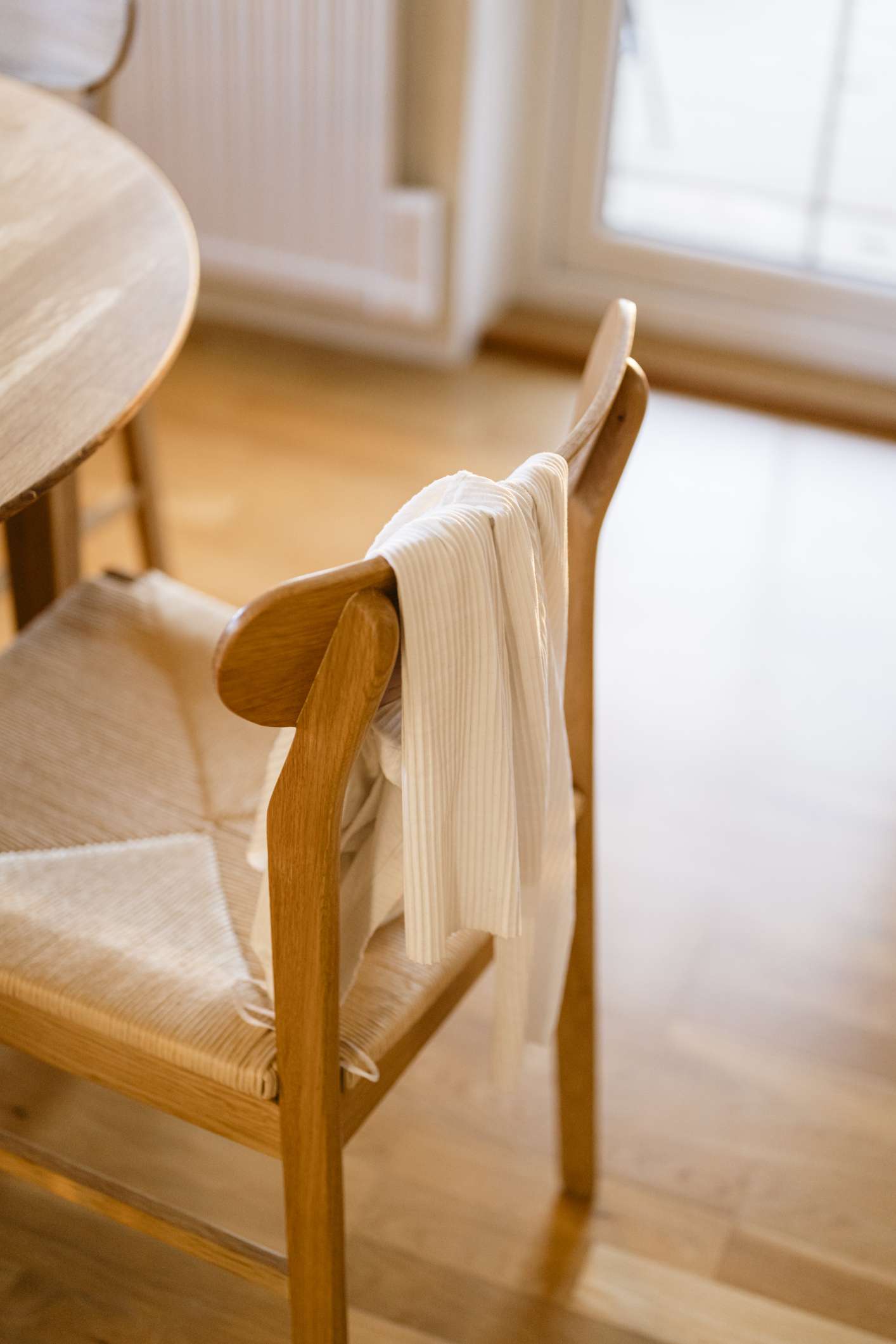 Clothing hanging on a chair in contemporary kitchen