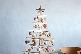 scandinavian christmas tree with wooden ornaments in living room