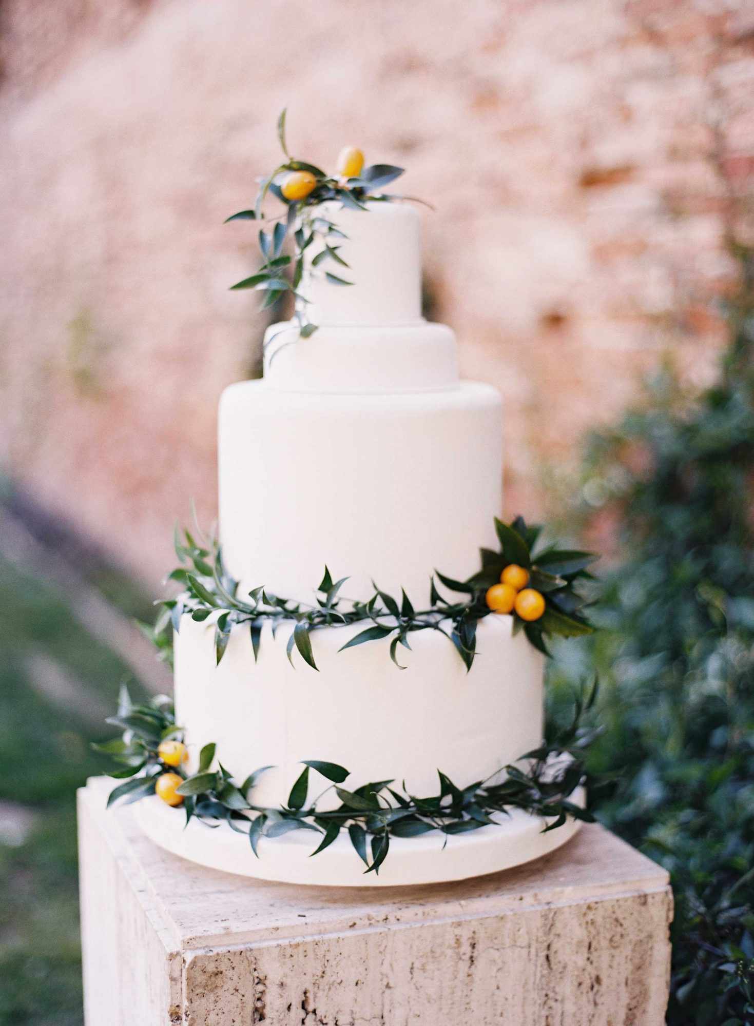 white cake with greenery