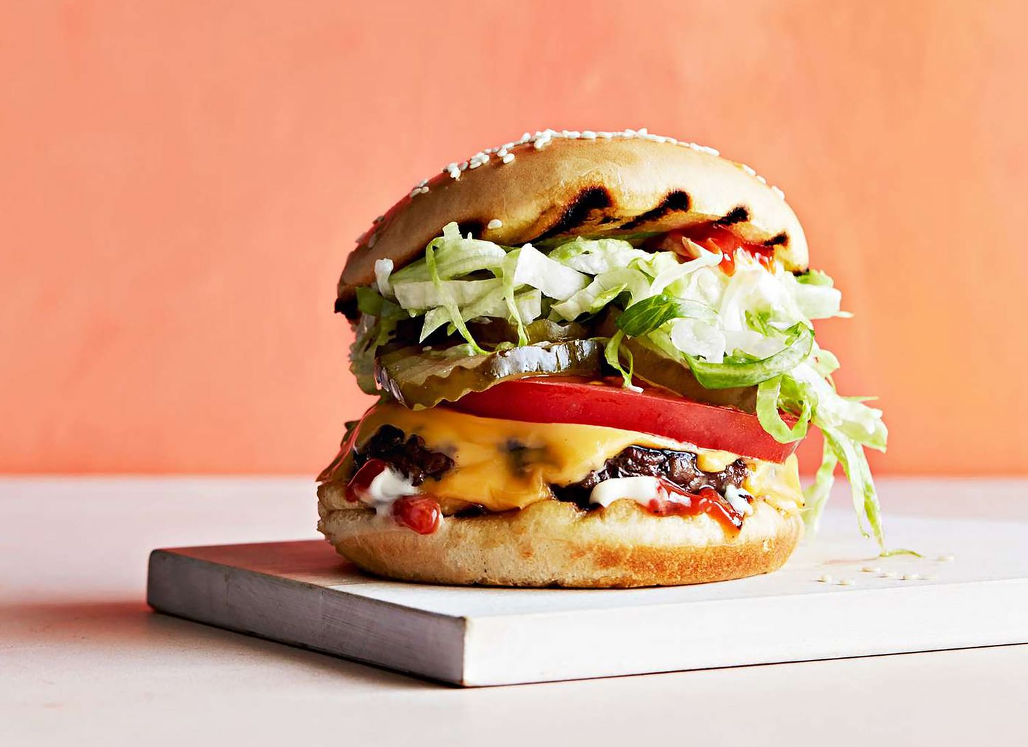 cheeseburger with a peach background