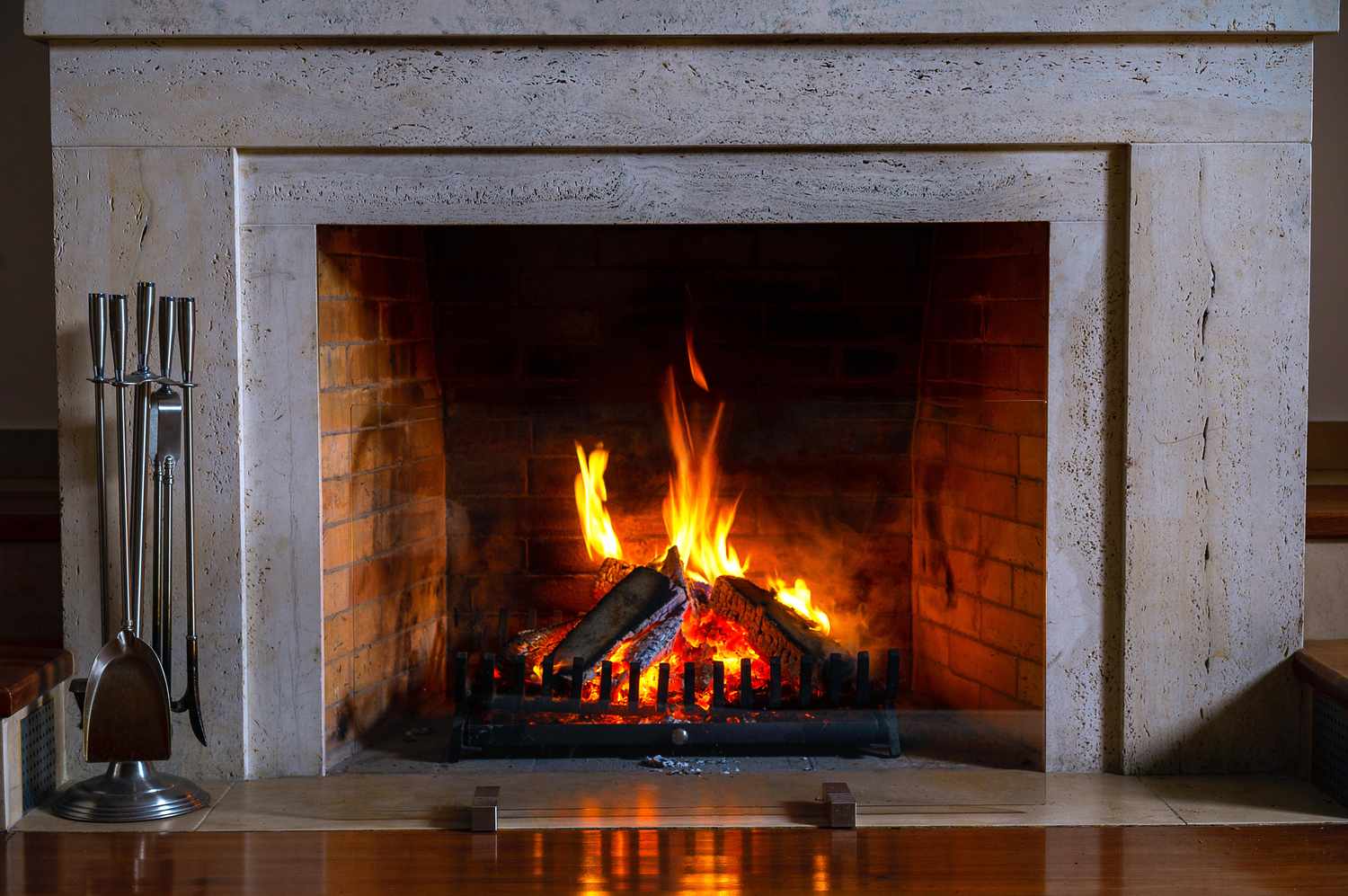 A lit fireplace with visible logs and flames emanating from the hearth