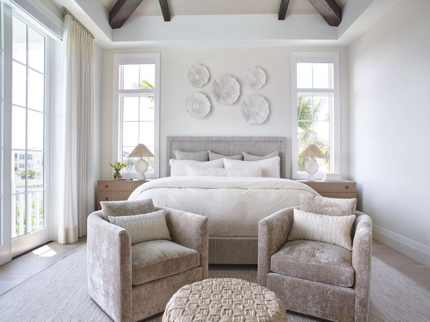 Bedroom with seating and ottoman at the foot of the bed