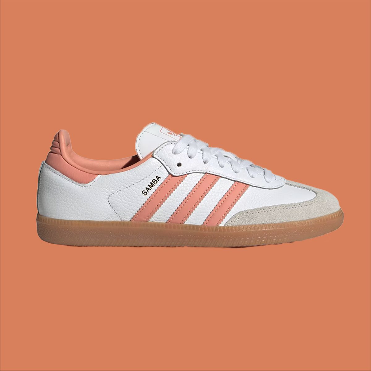 Adidas Samba white and pink tennis shoe on orange