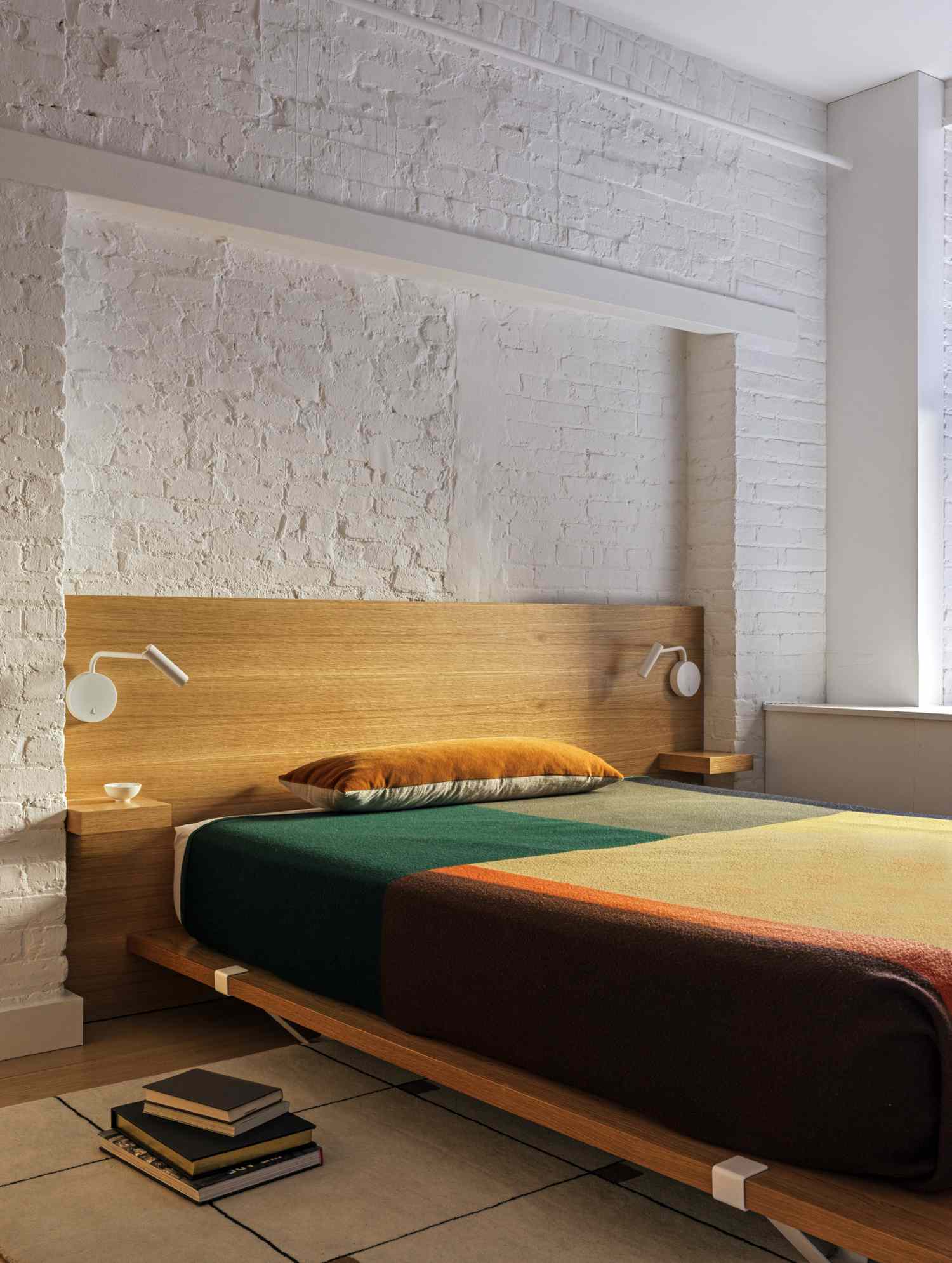 bed with white wall behind it 