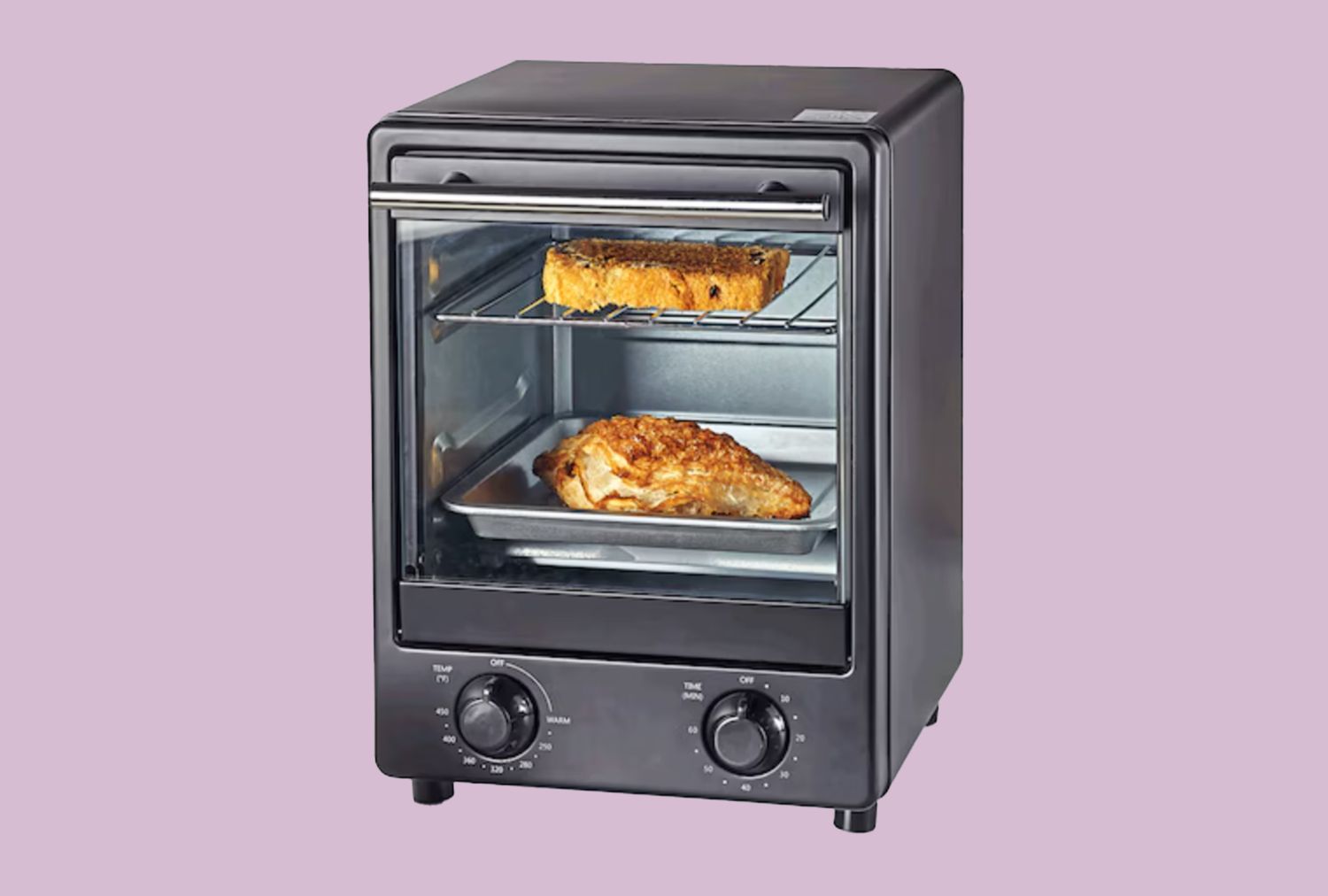 A compact black toaster oven with two dials features bread toasting on one rack and meat cooking on another