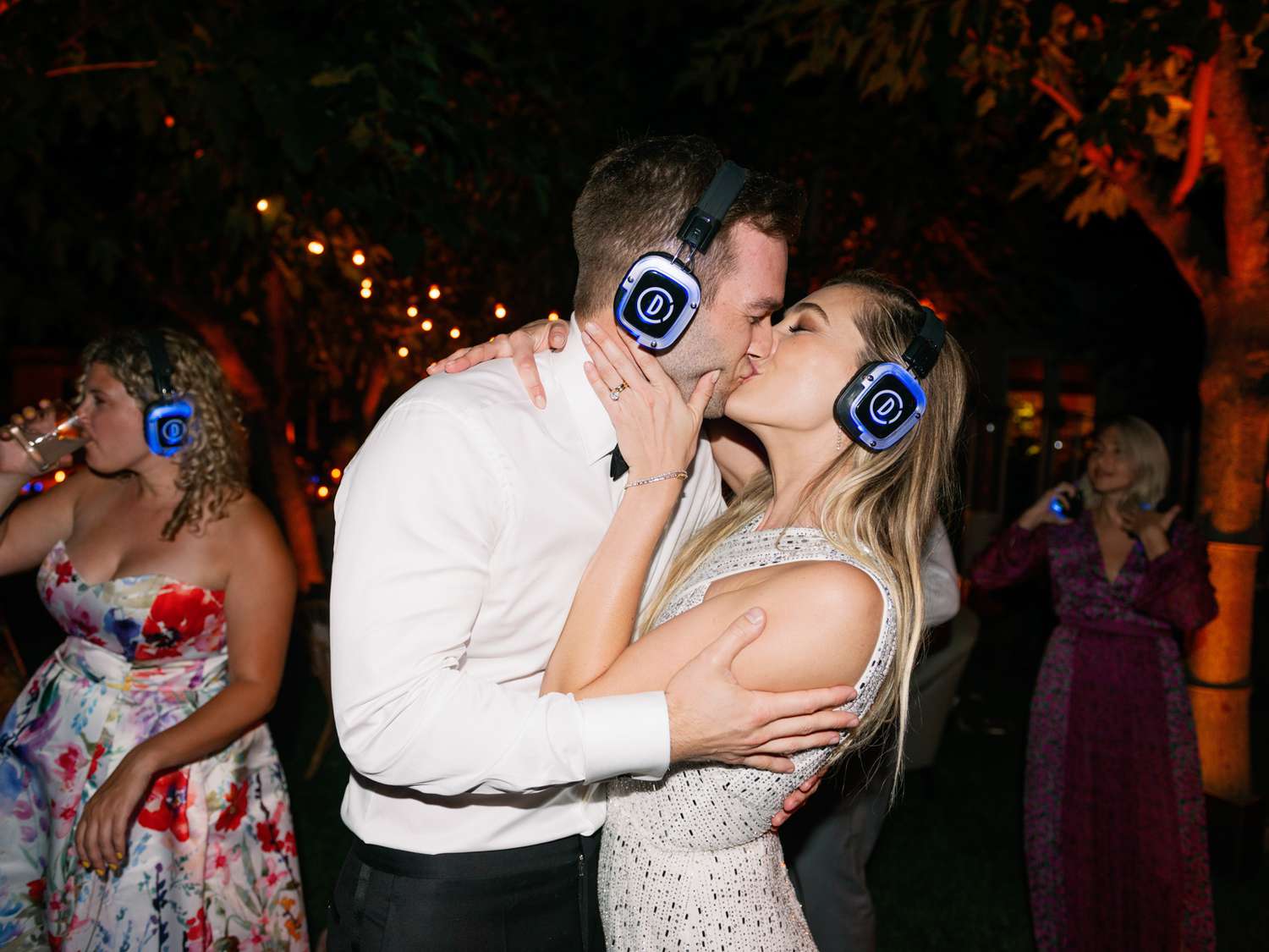 bride and groom kissing during reception silent disco