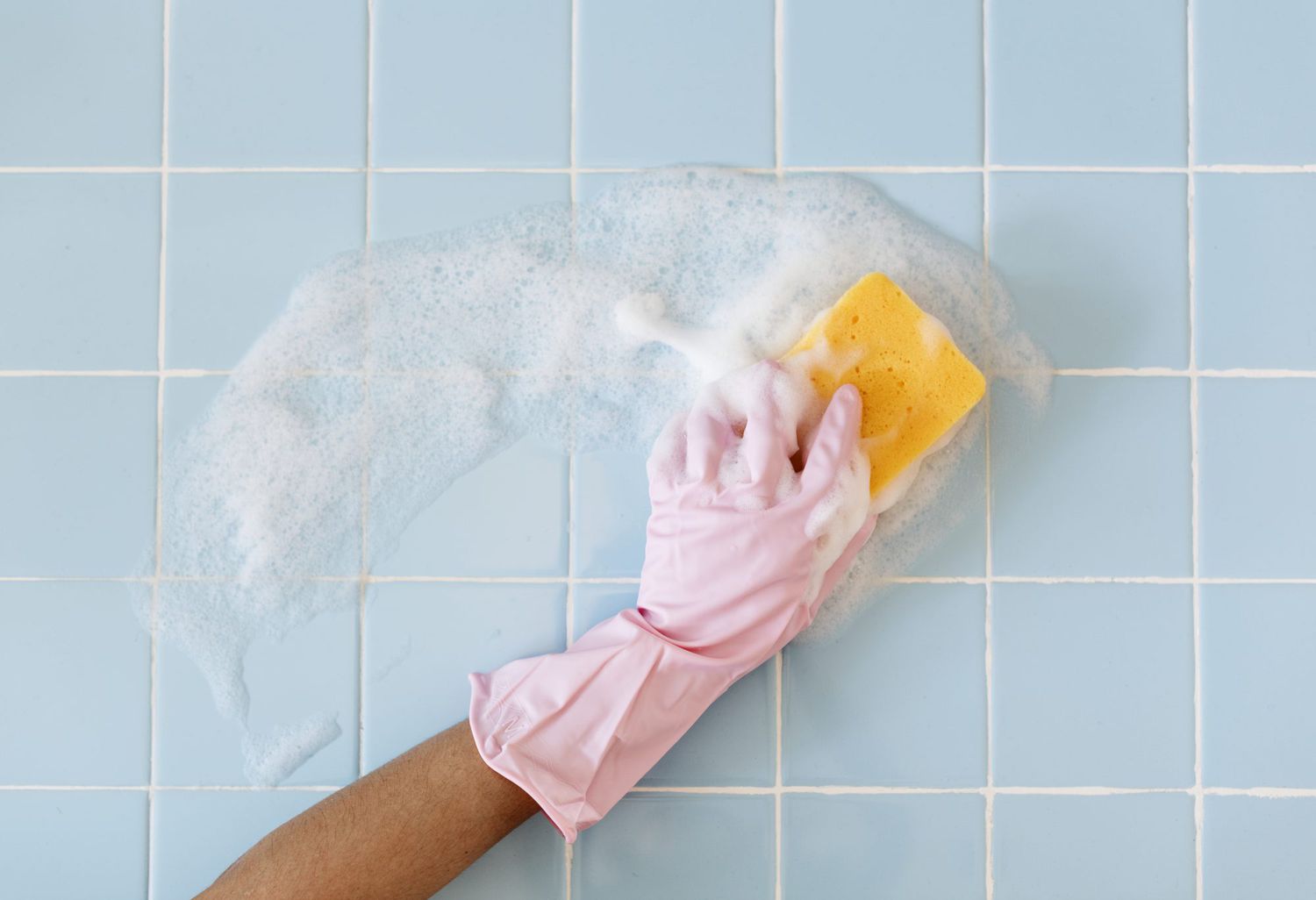 scrubbing bathroom tile walls