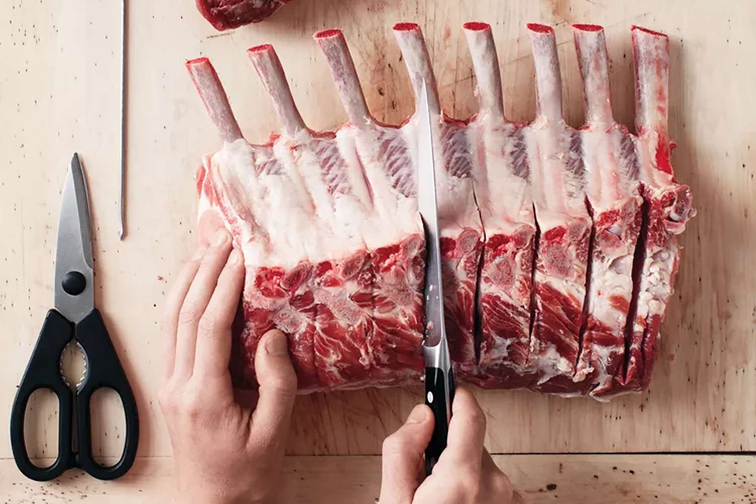 overhead view of someone cutting pork roast