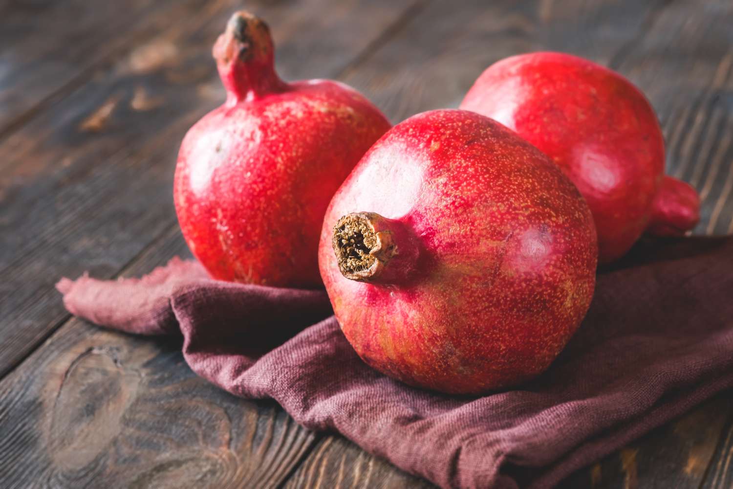 Three pomegranates on a cloth