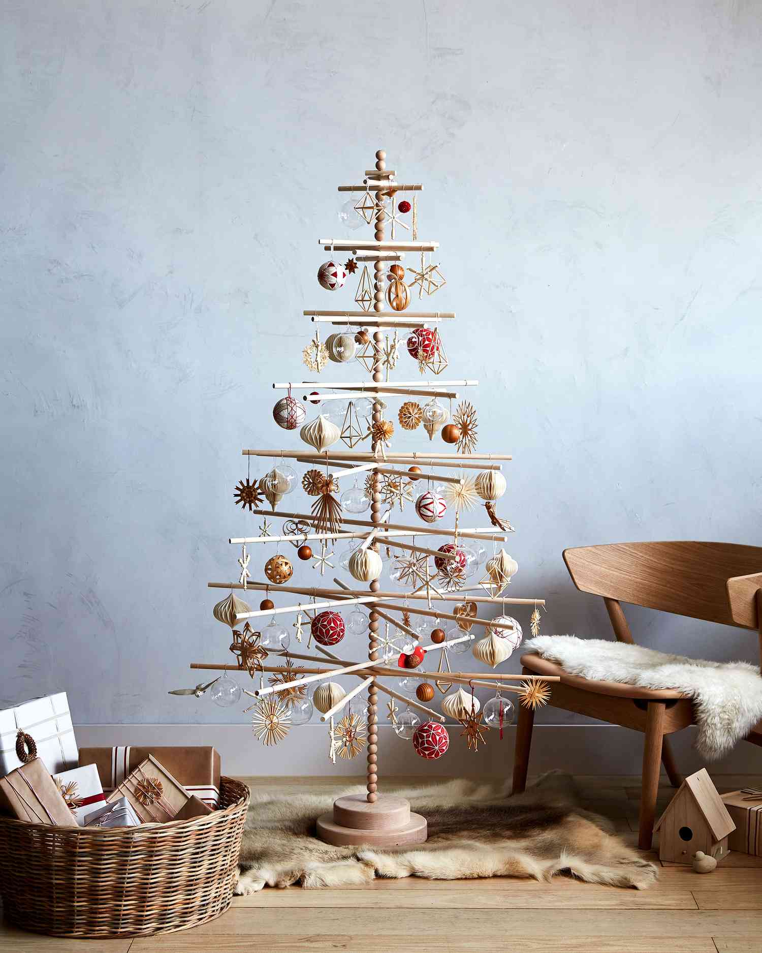 scandinavian christmas tree with wooden ornaments in living room