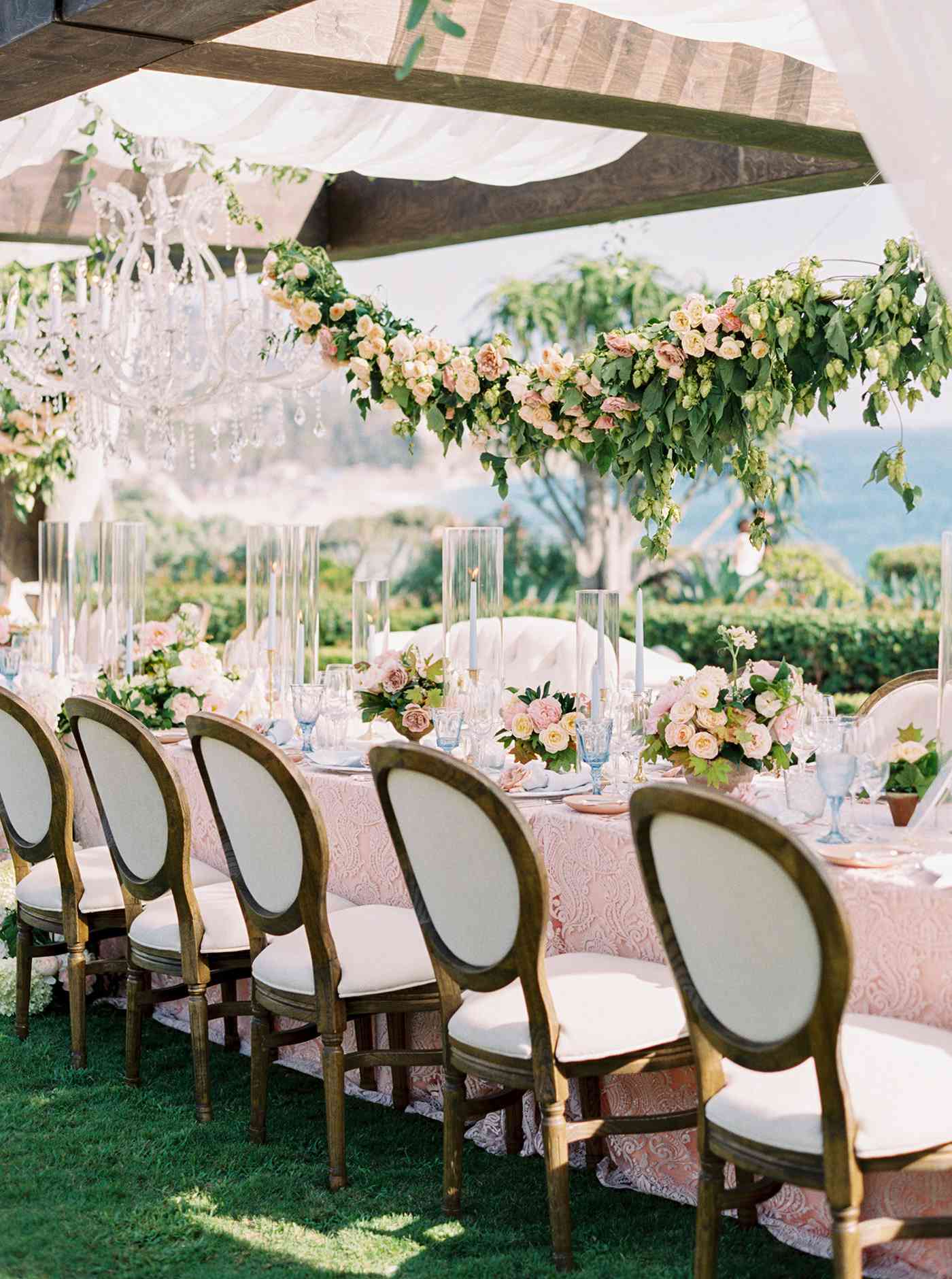 mykaela and brendon wedding blue and pink table setting with garland hanging above