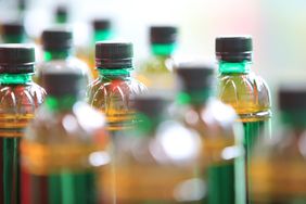 Array of bottled beverages with various liquid levels and caps