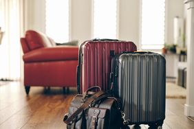 Red, gray, and leather suitcases