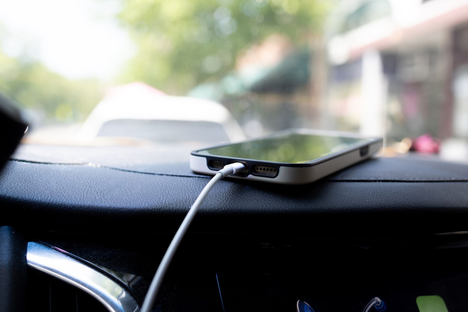 Phone charging on car dashboard