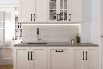 A modern kitchen interior featuring cabinets a backsplash and a sink