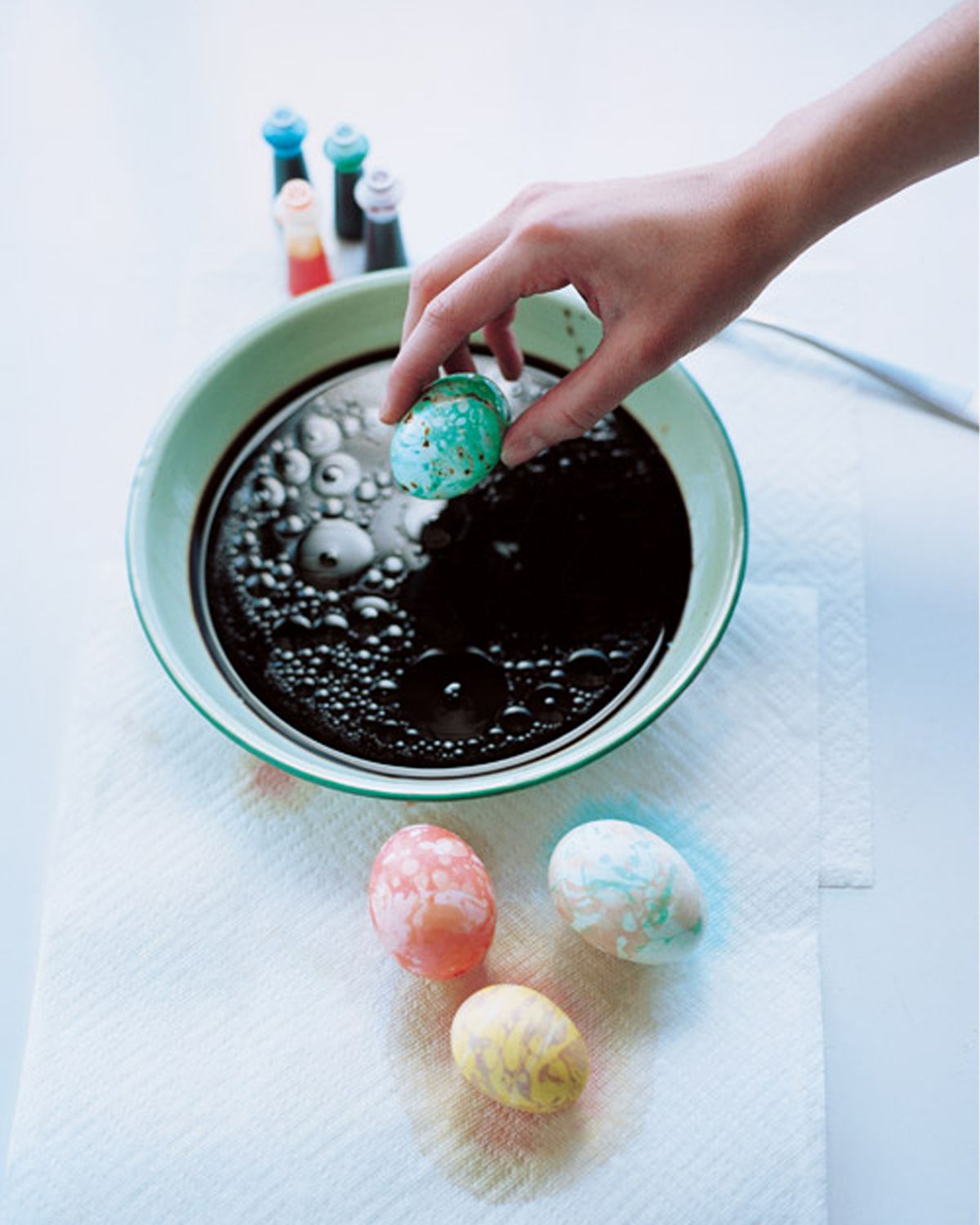 dipping eggs into egg dye