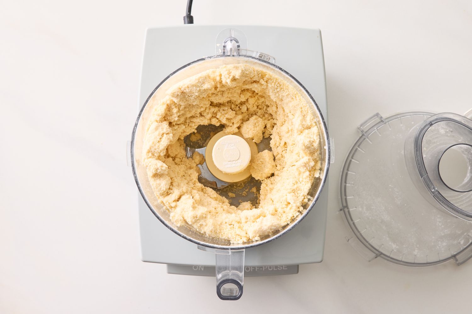 Food processor with cookie dough mixture lid removed viewed from above