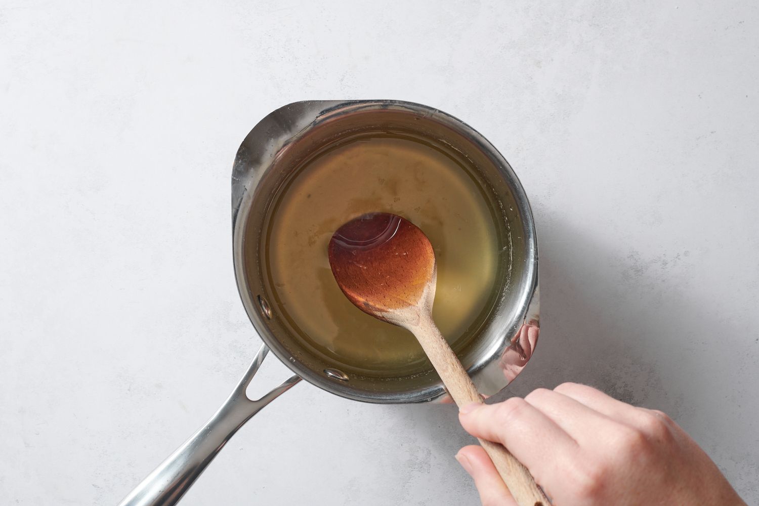 mixing lemon juice into sugar syrup