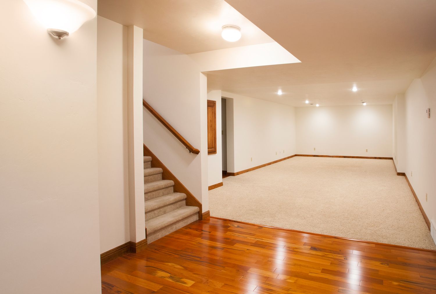 Finished basement with stairs hardwood flooring and carpeted area