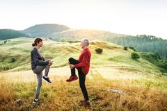 Two people in a field practicing balance exercises