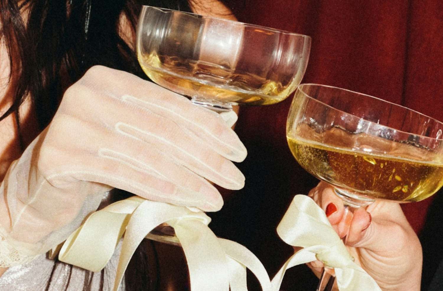 Two people clinking champagne glasses in celebration
