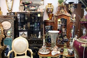 A collection of antique furniture decorative vases and curios displayed in a room