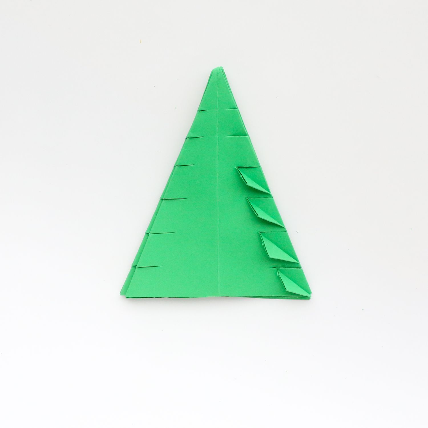 Piece of green paper folded into triangle