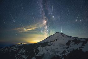 Meteor shower over a snowy mountain with the Milky Way in the night sky