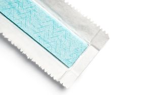 A piece of chewing gum partially wrapped in its paper