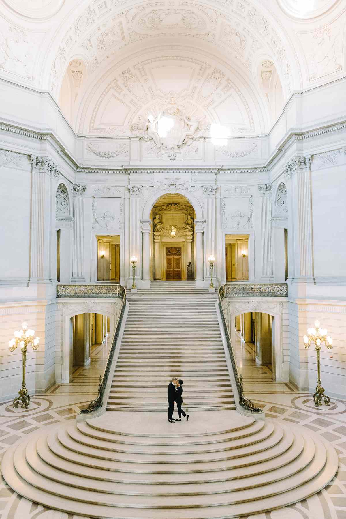 grooms standing in the middle of city hall