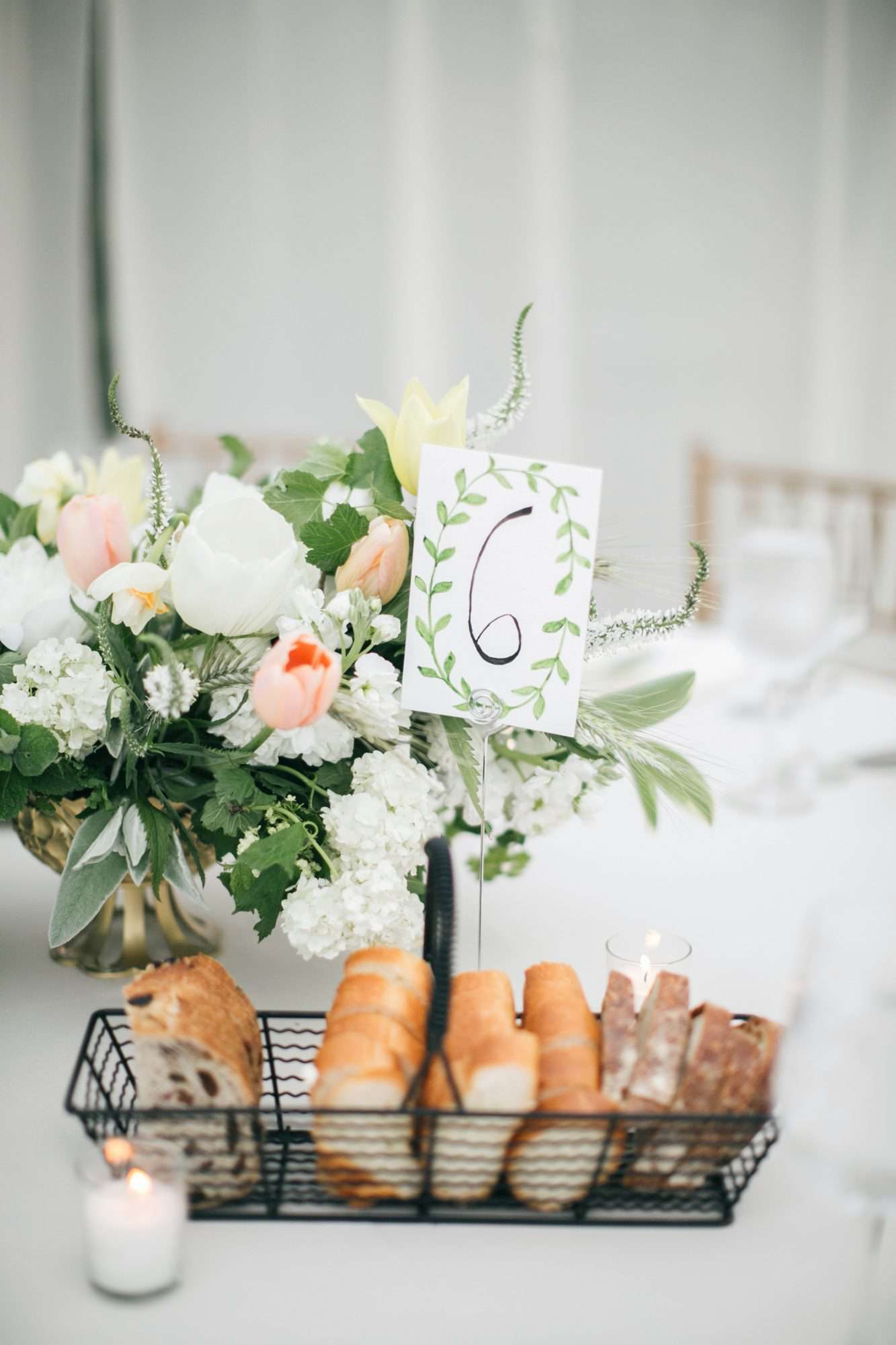 wire basket of bread holding table number