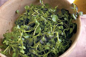 watercress salad in a wooden bowl