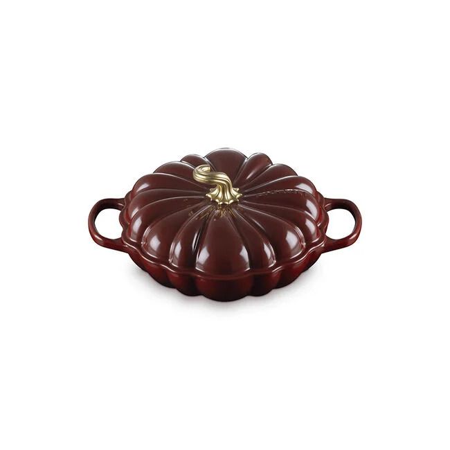 A pumpkinshaped cooking dish with handles and a lid styled to resemble a pumpkin