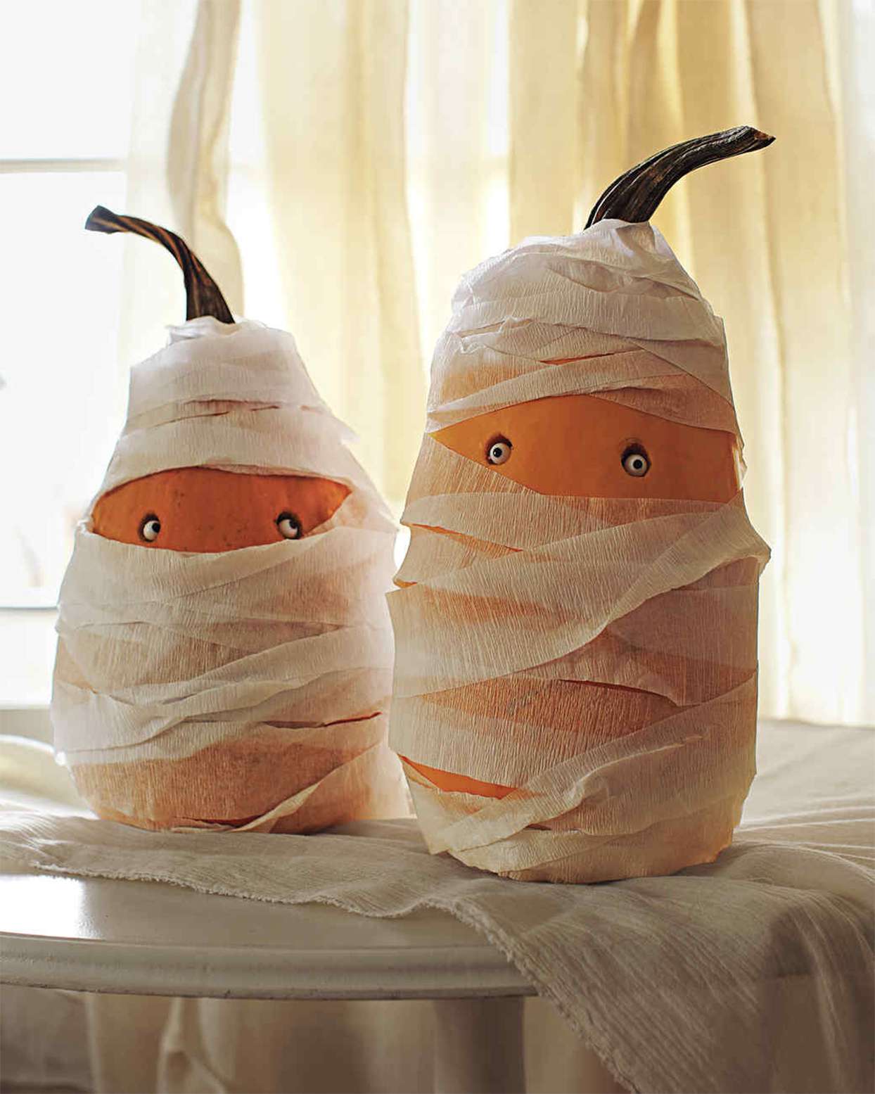 wrapped pumpkins resembling mummies