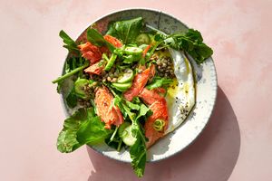 Salmon with lentil salad and greens on a plate